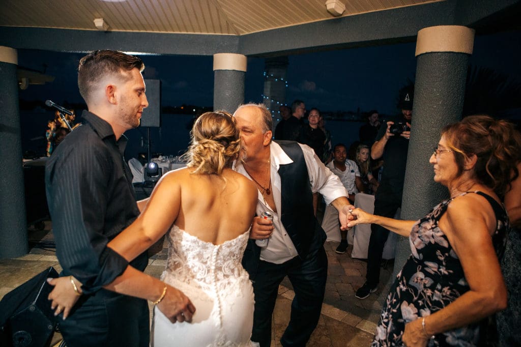 Bride kissing father during reception at wedding in St. Pete